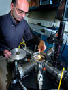 Dimitrios Peroulis, an assistant professor of electrical and computer engineering at Purdue, holds a new MEMS sensor. (Purdue News Service photo/David Umberger)